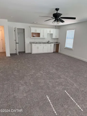 a view of a kitchen with a sink and a window