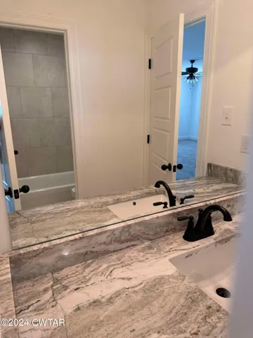 a bathroom with a toilet a sink and bathtub