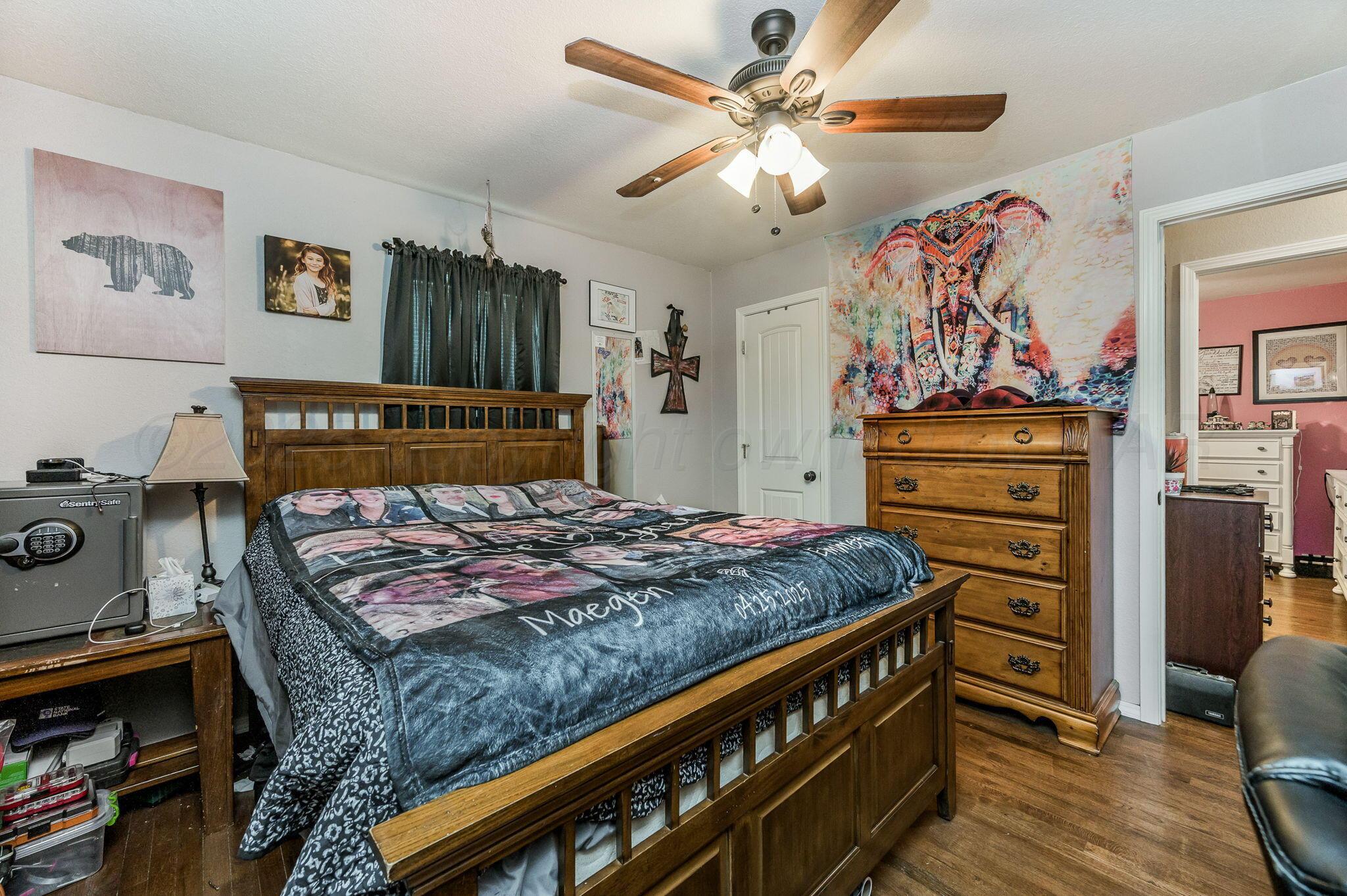 4114 South Hayden Street Amarillo, TX 79110 - Photo 12 of 18 a bedroom with a bed and a flat tv screen in it