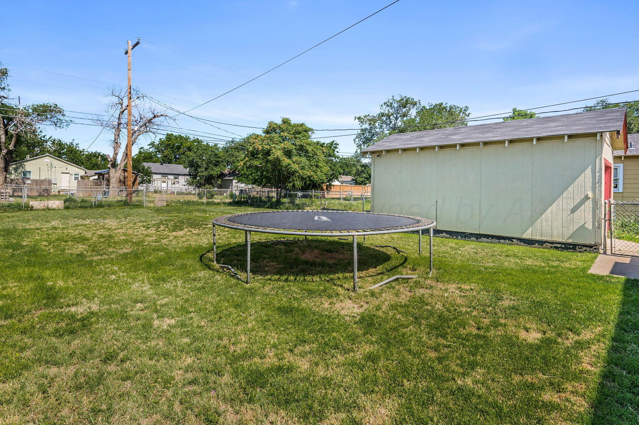 4114 South Hayden Street Amarillo, TX 79110 - Photo 16 of 18 a wooden fence with some trees in the background