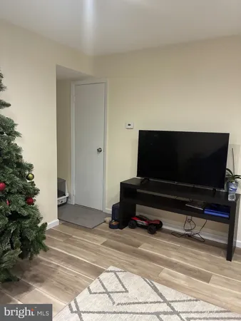 a view of a room with furniture and wooden floor