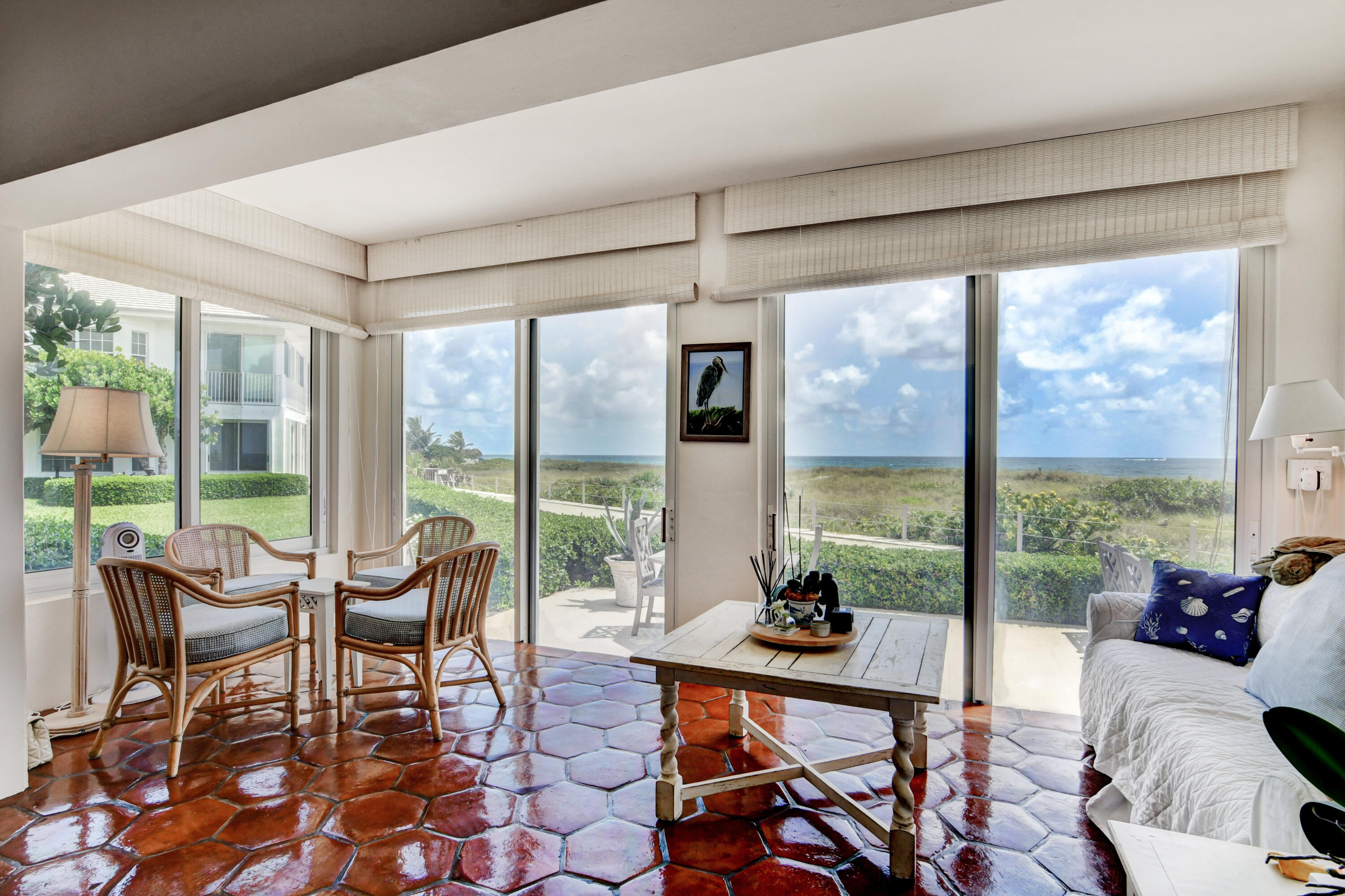 801 North Ocean Boulevard Delray Beach, FL 33483 - Photo 13 of 37 a living room with furniture and a floor to ceiling window