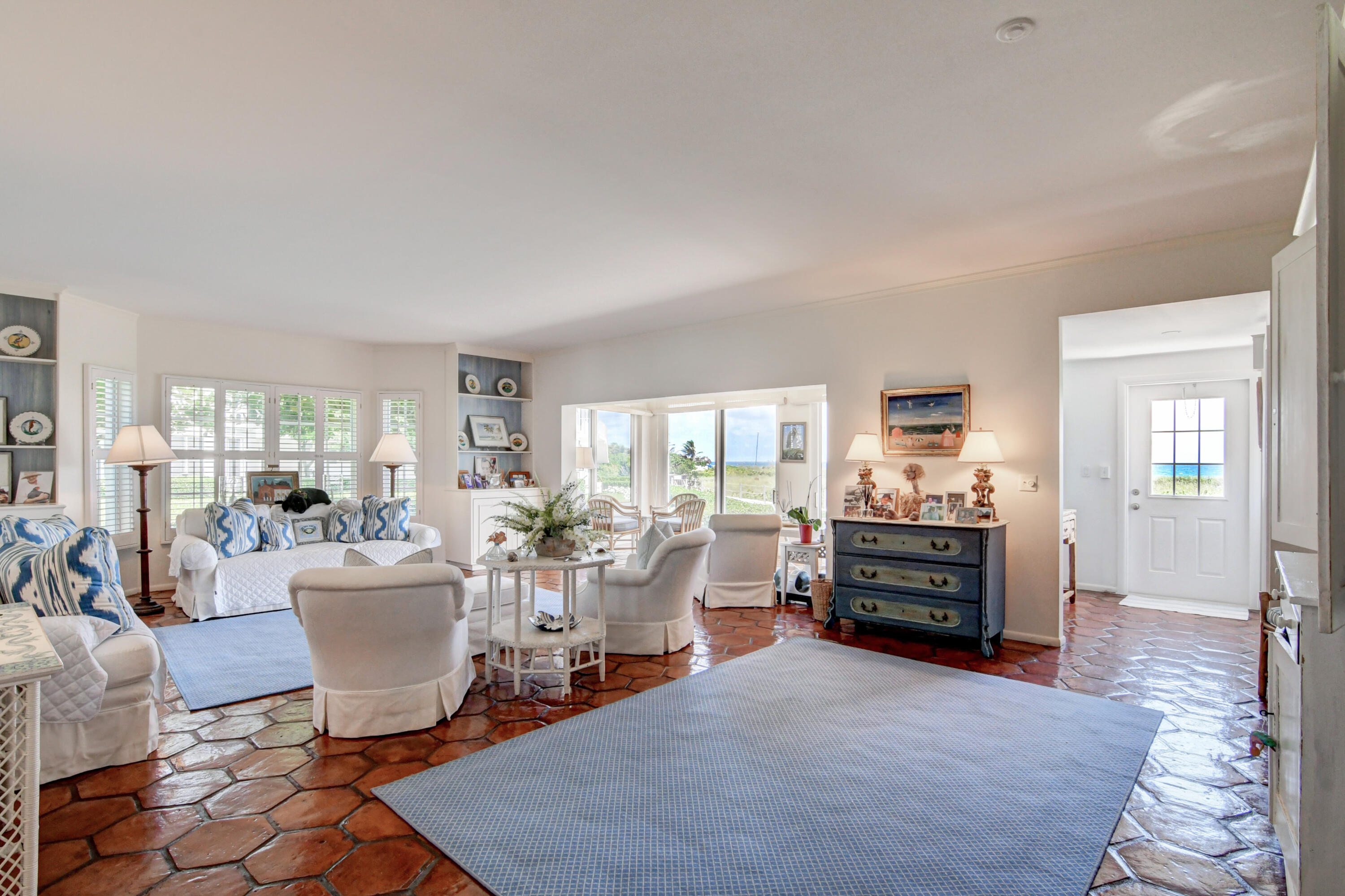 801 North Ocean Boulevard Delray Beach, FL 33483 - Photo 8 of 37 a living room with furniture a fireplace and large windows