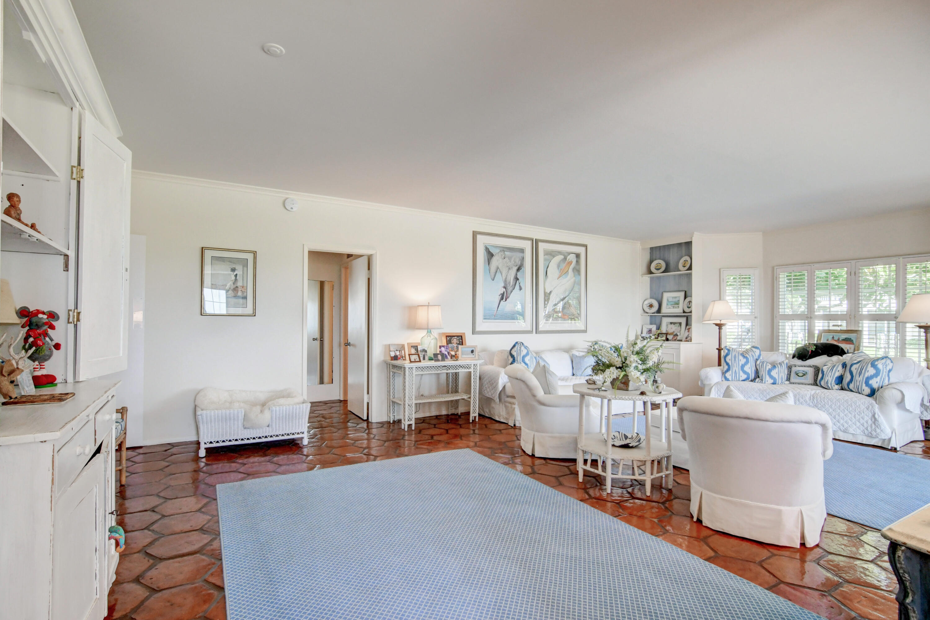 801 North Ocean Boulevard Delray Beach, FL 33483 - Photo 9 of 37 a living room with furniture a wooden floor and a lamp