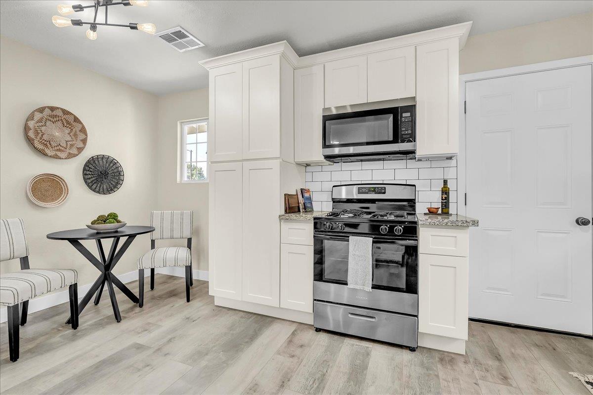8685 Eddy Street Hanford, CA 93230 - Photo 13 of 45 a kitchen with a stove and a microwave