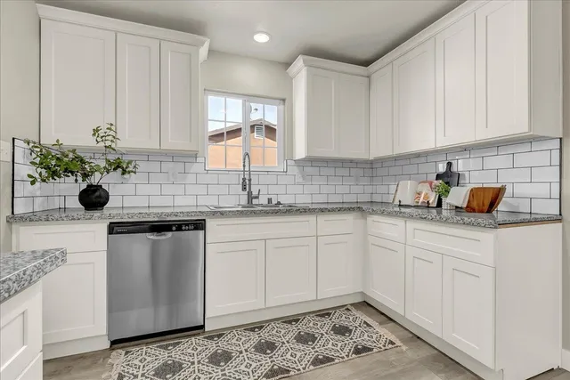 a kitchen with a sink cabinets and wooden floor