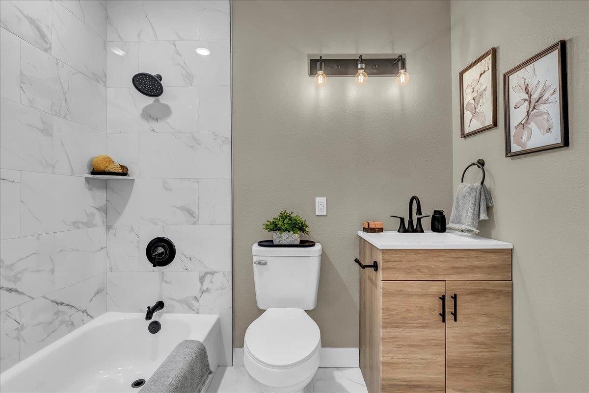 8685 Eddy Street Hanford, CA 93230 - Photo 16 of 45 a bathroom with a sink a toilet and shower