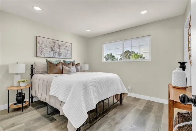 a bedroom with a bed and a painting on the wall