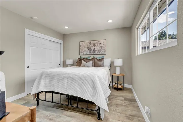 a bedroom with a bed and a chandelier