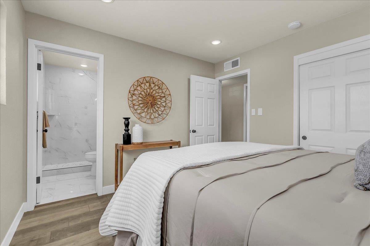 8685 Eddy Street Hanford, CA 93230 - Photo 23 of 45 a bedroom with a bed and a chandelier