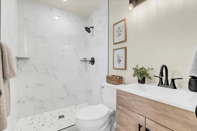 a bathroom with a sink a toilet and a mirror