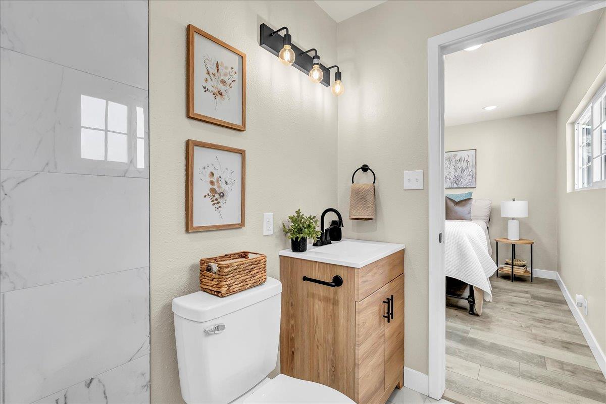 8685 Eddy Street Hanford, CA 93230 - Photo 25 of 45 a bathroom with a sink a toilet and a mirror