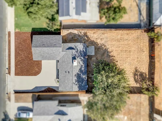 a view of house with backyard and a garden