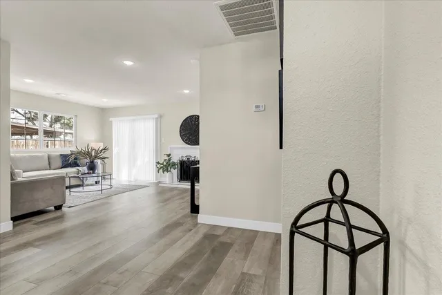 a view of dining room and livingroom with furniture wooden floor and windows
