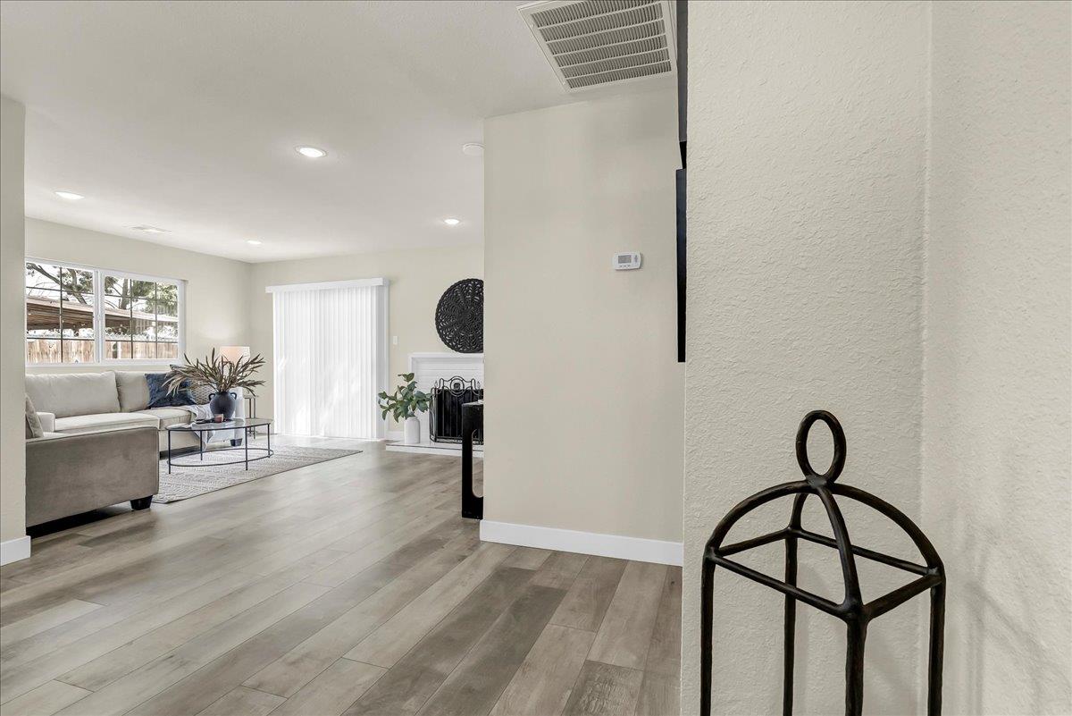 8685 Eddy Street Hanford, CA 93230 - Photo 4 of 45 a view of dining room and livingroom with furniture wooden floor and windows
