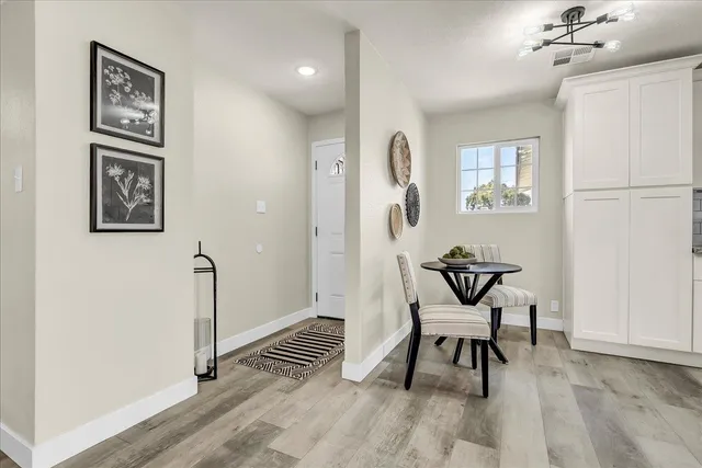 a view of a room with furniture and wooden floor