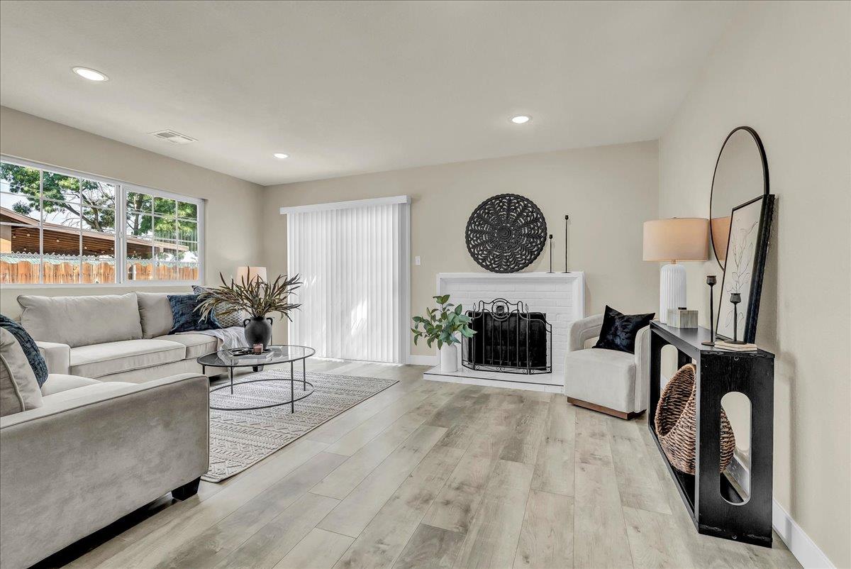 8685 Eddy Street Hanford, CA 93230 - Photo 6 of 45 a living room with furniture a fireplace and white walls