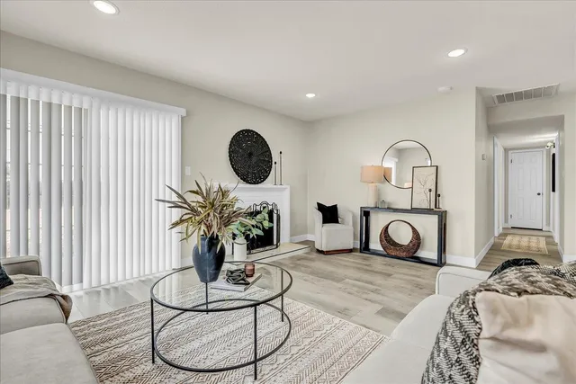 a living room with furniture a rug and a window