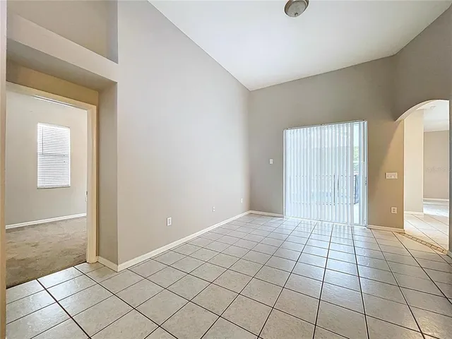 a view of a livingroom with a ceiling fan and window