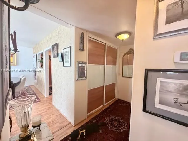 a bathroom with a glass door shower a mirror and a sink