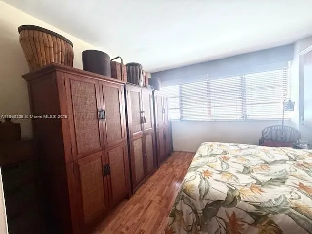 a bedroom with a bed cabinet and window