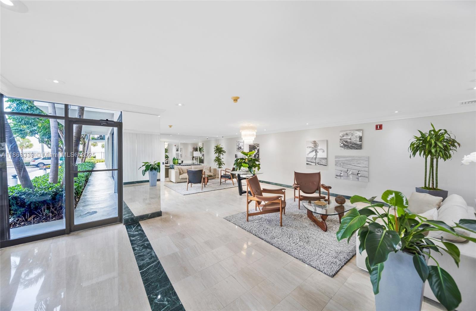 1408 Brickell Bay Drive, Unit 303 Miami, FL 33131 - Photo 19 of 24 a living room with furniture a potted plant and a large window