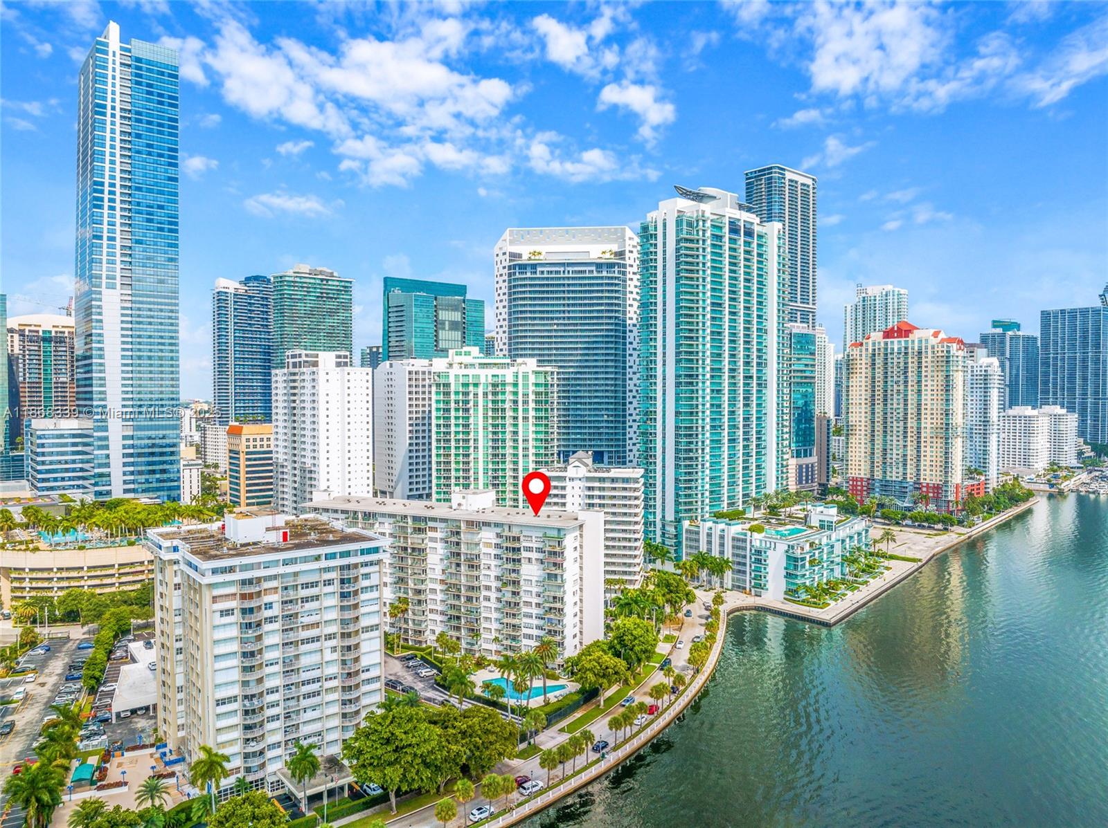 1408 Brickell Bay Drive, Unit 303 Miami, FL 33131 - Photo 2 of 24 a view of building with outdoor space and swimming pool