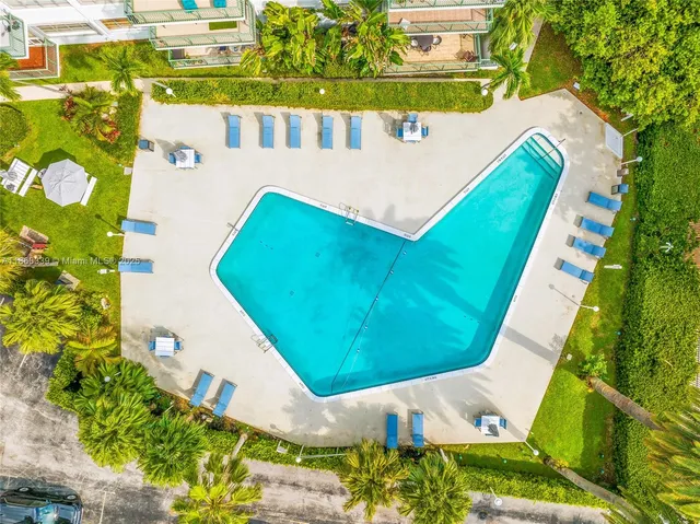 a view of a swimming pool with a yard