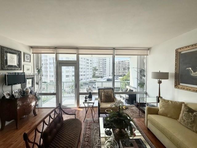 1408 Brickell Bay Drive, Unit 303 Miami, FL 33131 - Photo 4 of 24 a living room with furniture and a flat screen tv