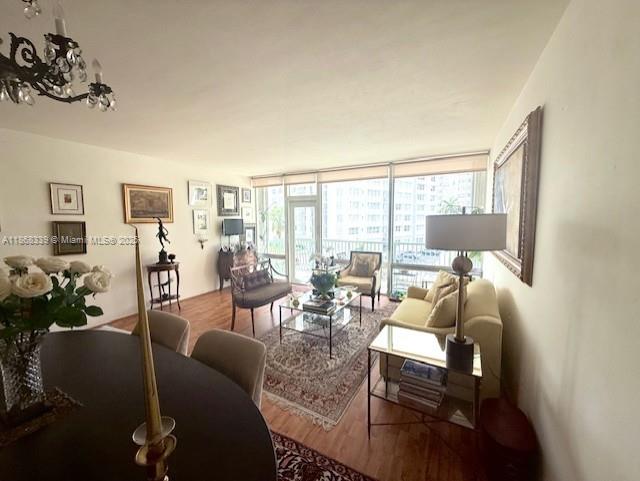 1408 Brickell Bay Drive, Unit 303 Miami, FL 33131 - Photo 7 of 24 a living room with furniture and a large window