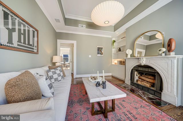 a living room with furniture a rug and a fireplace