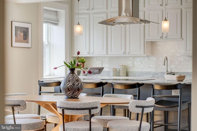 a dining room with furniture and a chandelier