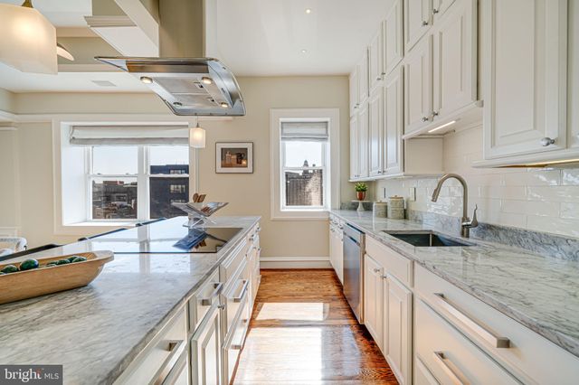 a kitchen with stainless steel appliances granite countertop a sink and stove