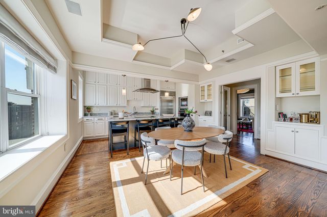 a view of a dining room with furniture wooden floor and chandelier