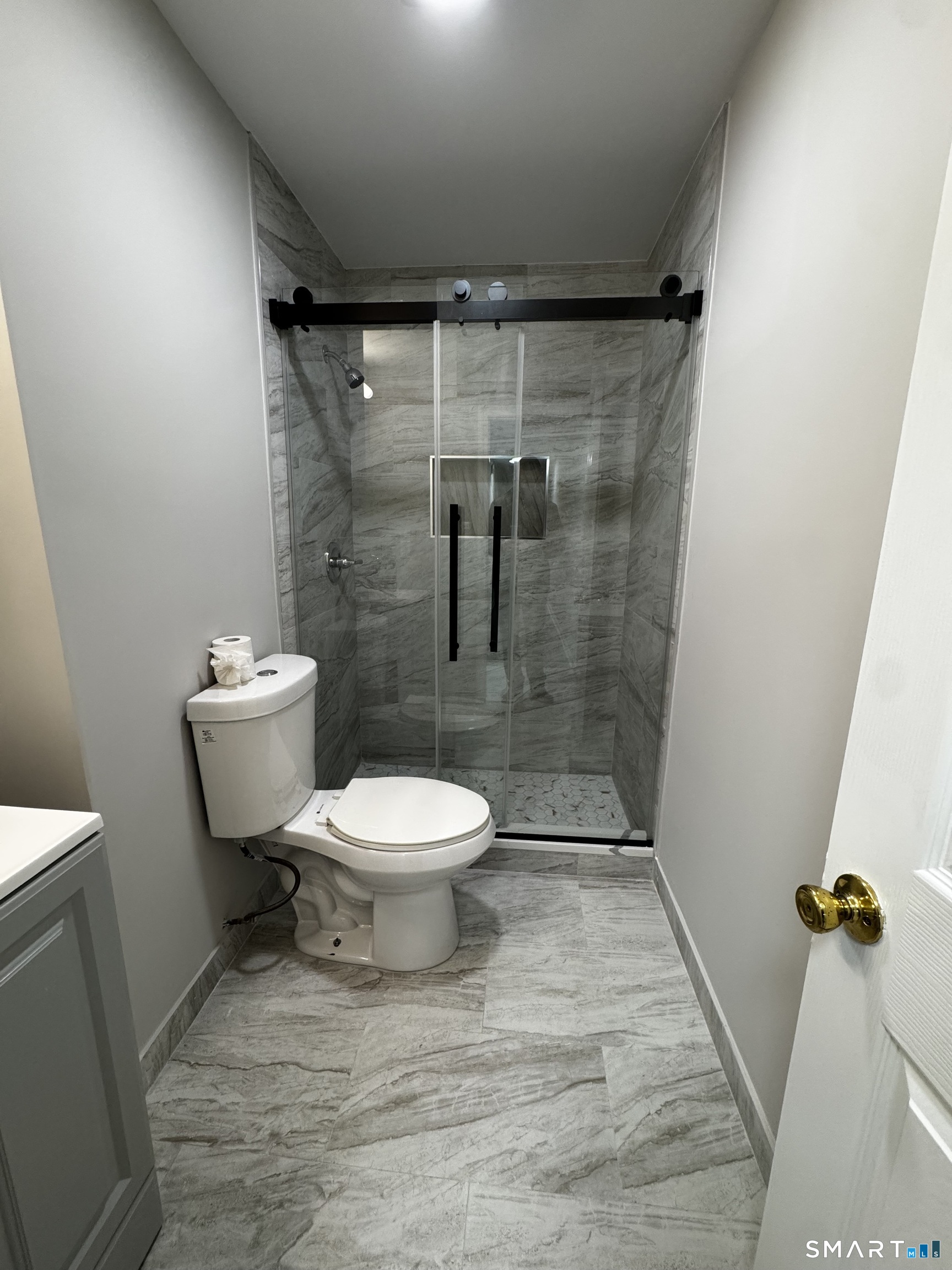 45-51 Cowles Street, Unit 45 Bridgeport, CT 06607 - Photo 16 of 33 completely renovated bathroom with new vanity, new medicine cabinet, new standup shower with frameless sliding glass door, new tile floor, new lighting and paint
