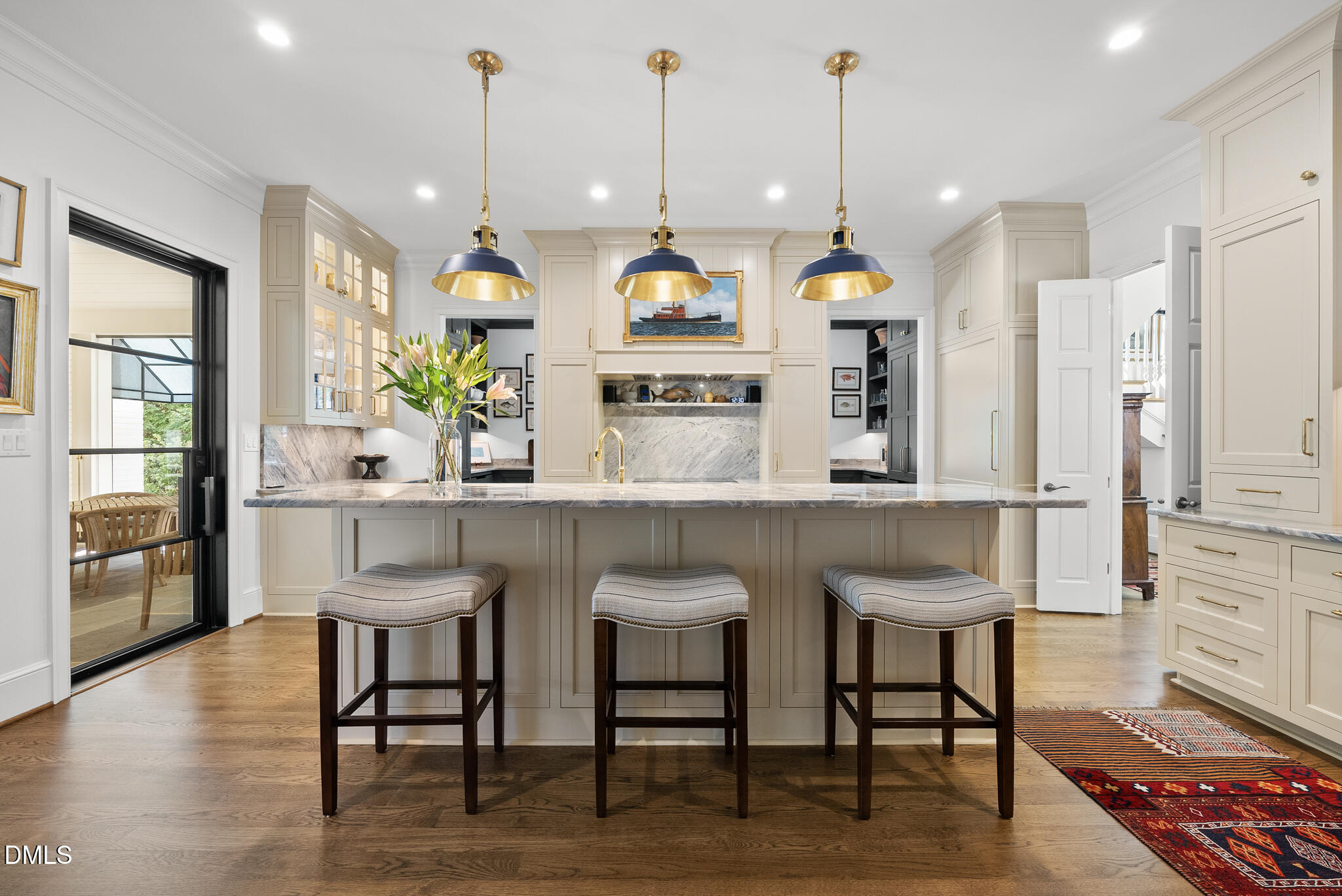 1312 Duplin Road Raleigh, NC 27607 - Photo 21 of 90 a kitchen with stainless steel appliances kitchen island granite countertop a table chairs and a refrigerator