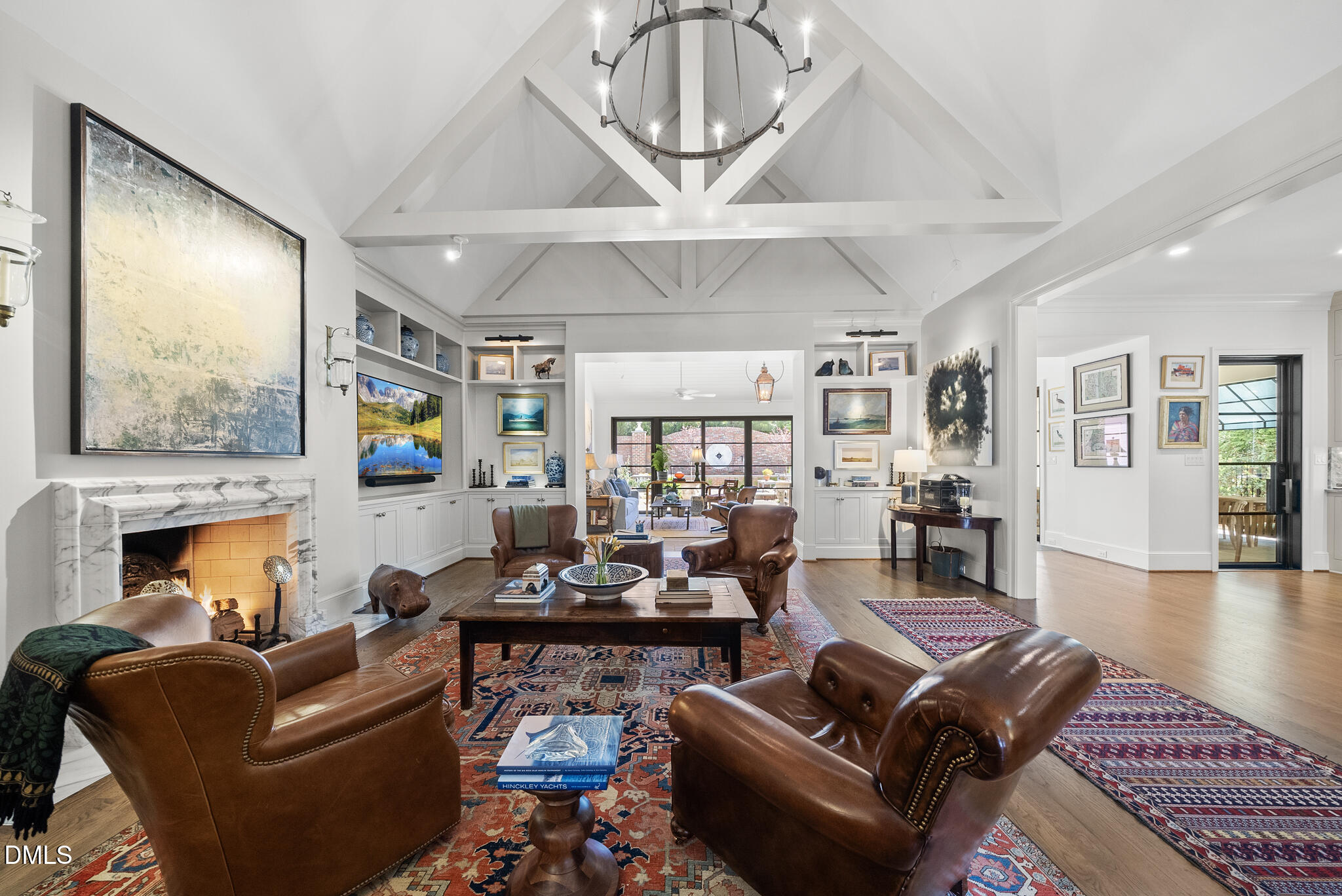 1312 Duplin Road Raleigh, NC 27607 - Photo 32 of 90 a living room with furniture a fireplace and a chandelier