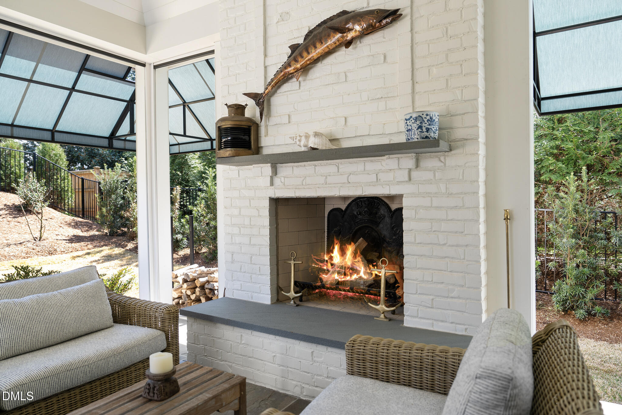 1312 Duplin Road Raleigh, NC 27607 - Photo 69 of 90 a living room with furniture a fireplace and a floor to ceiling window