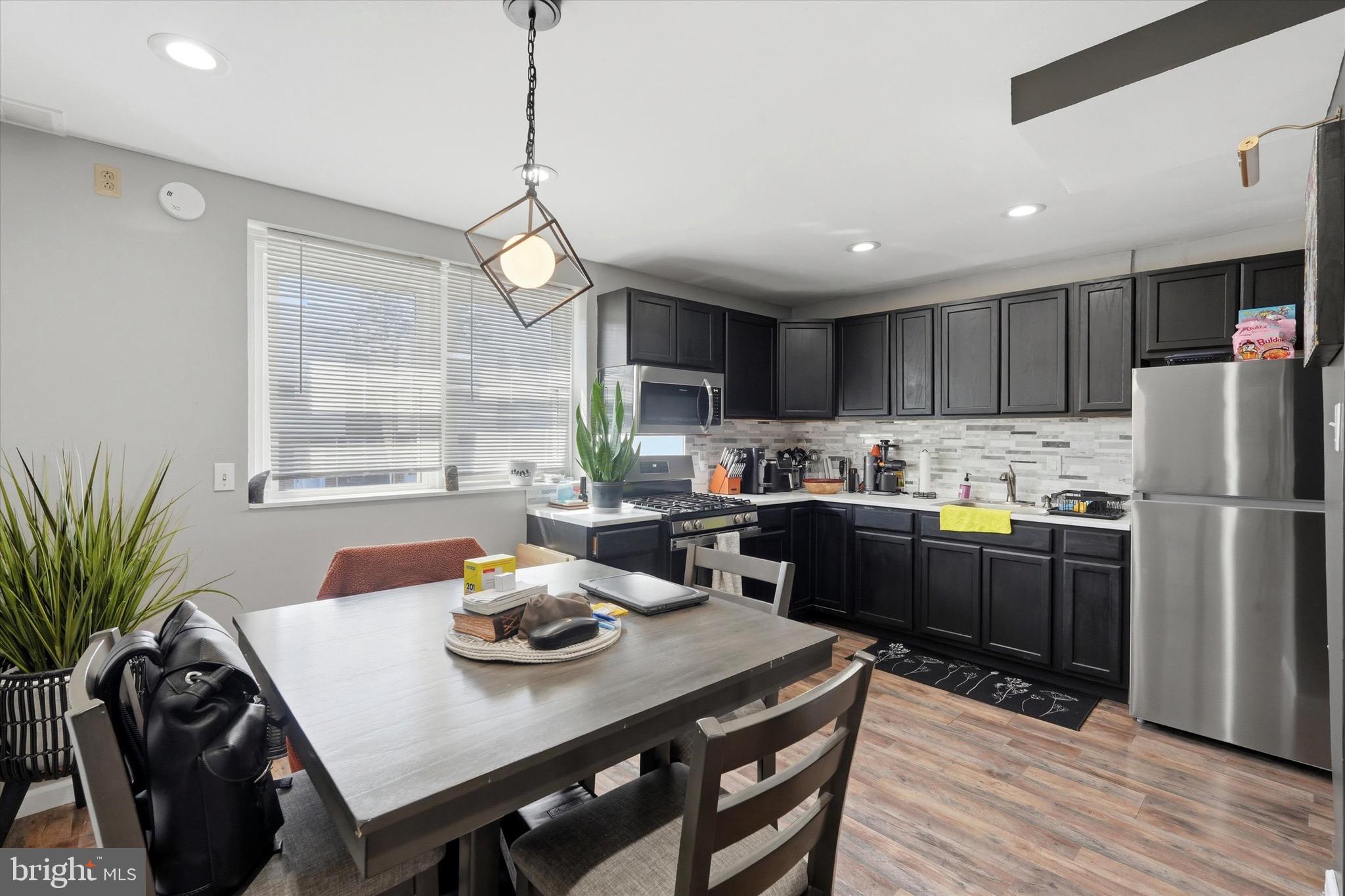 4604 Meridian Street Philadelphia, PA 19136 - Photo 4 of 15 a kitchen with refrigerator cabinets dining table and chairs