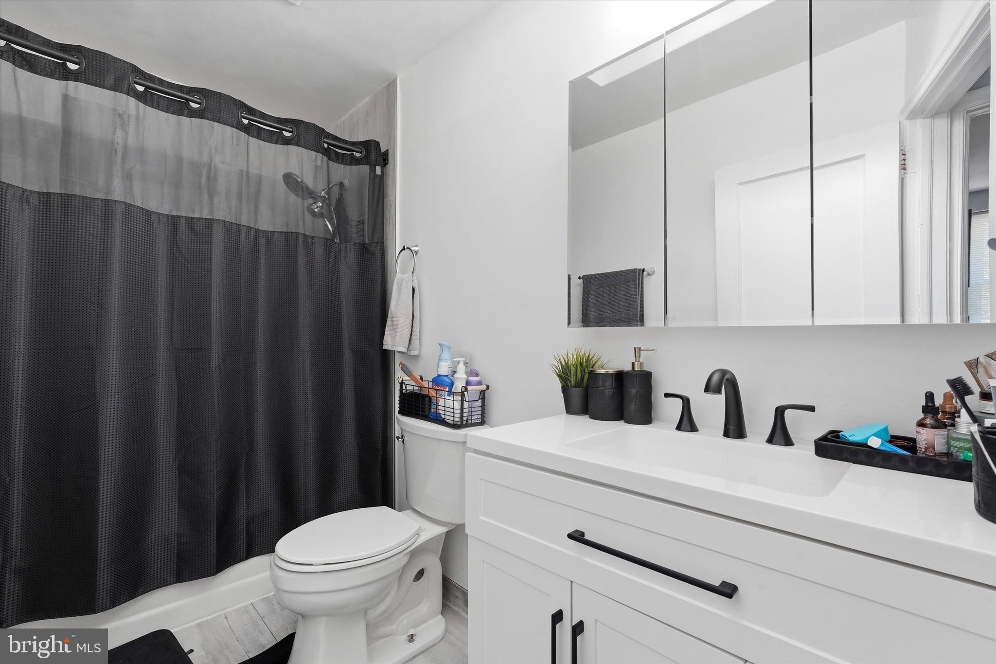 4604 Meridian Street Philadelphia, PA 19136 - Photo 9 of 15 a bathroom with a sink a toilet a shower and a mirror