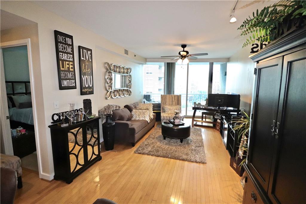 3338 Peachtree Road Northeast, Unit 1606 Atlanta, GA 30326 - Photo 1 of 1 a living room with furniture fireplace and flat screen tv
