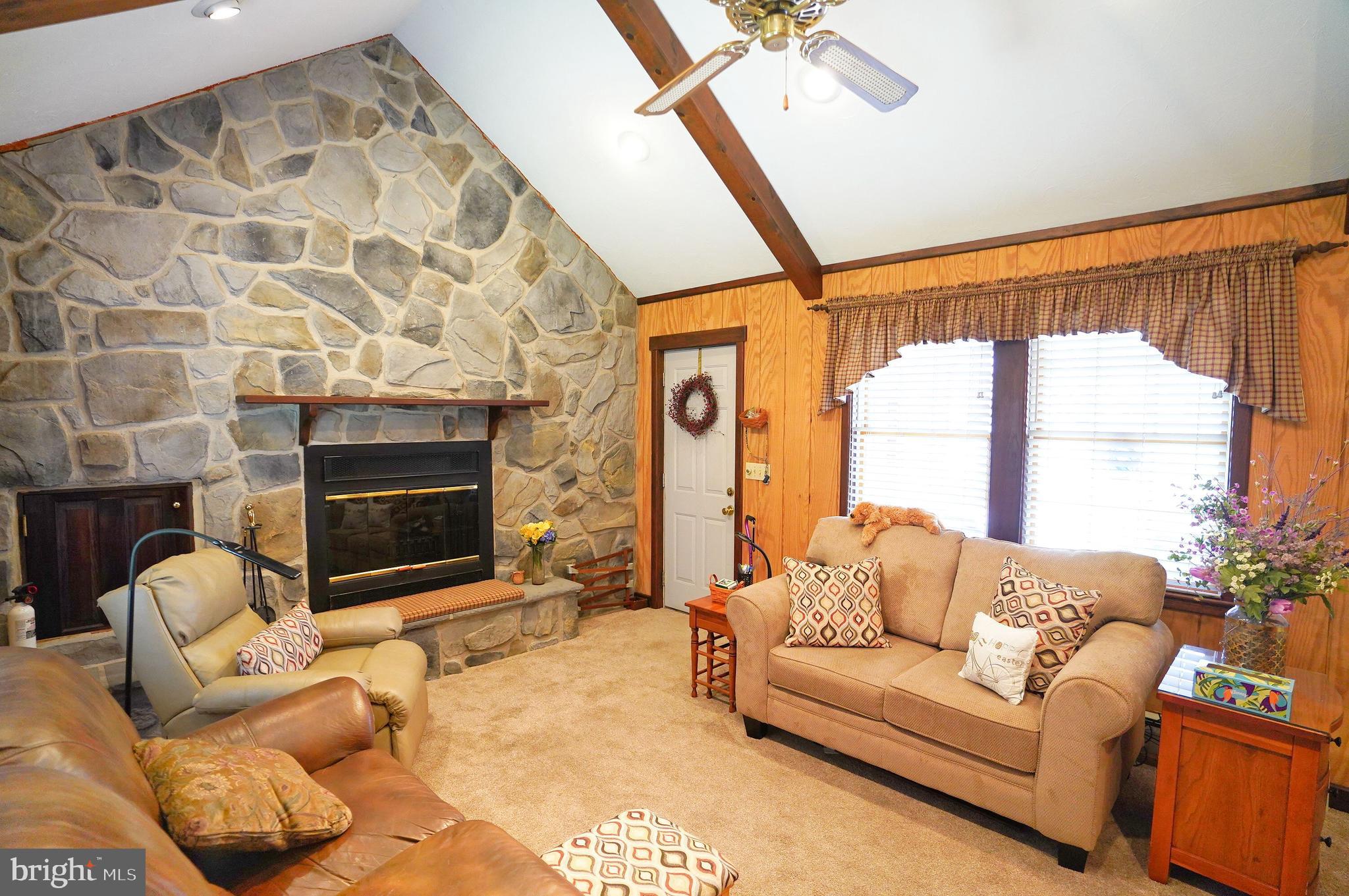 245 Montclair Road Gettysburg, PA 17325 - Photo 14 of 32 a living room with furniture a flat screen tv and a fireplace