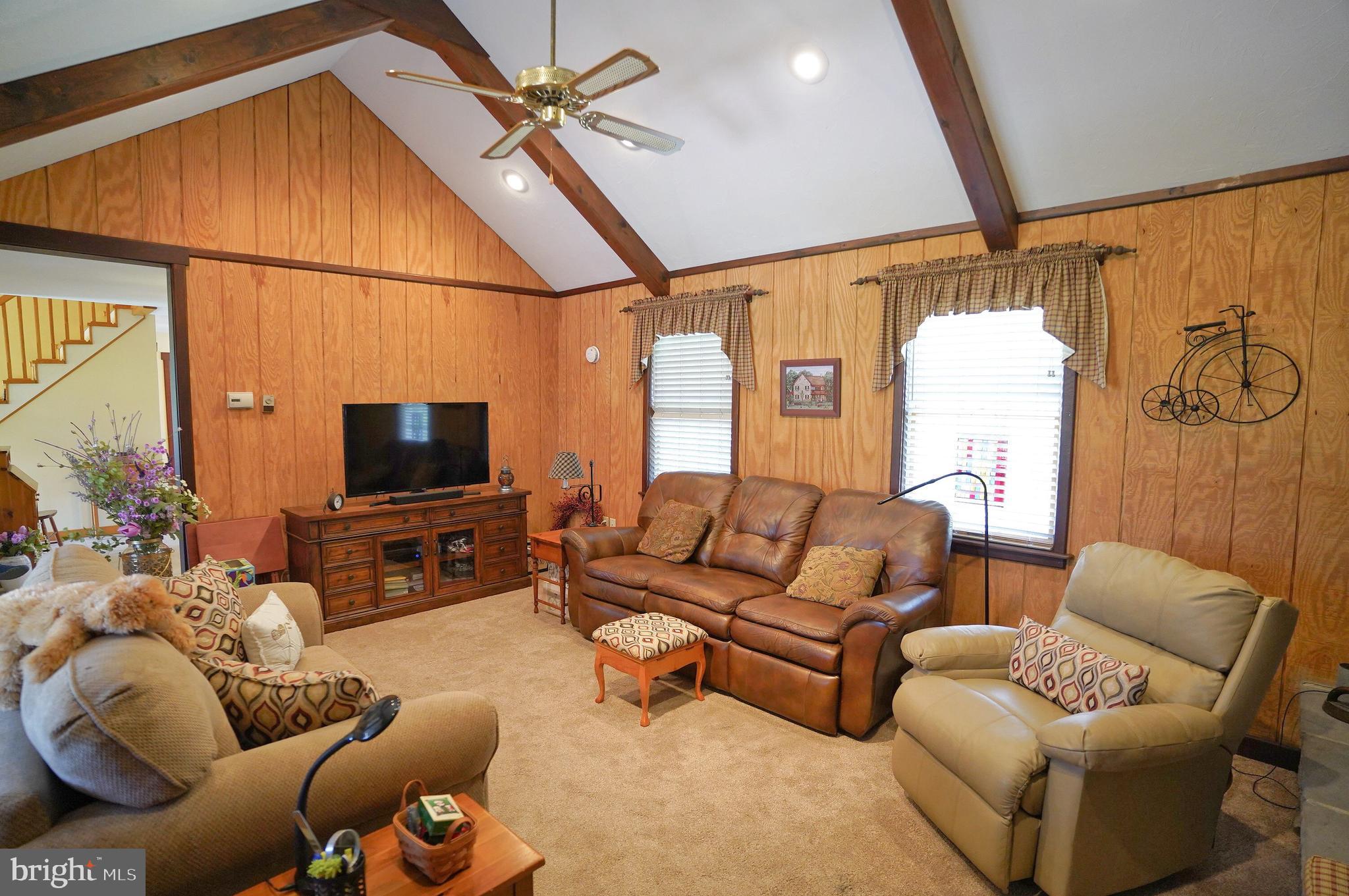 245 Montclair Road Gettysburg, PA 17325 - Photo 15 of 32 a living room with furniture a ceiling fan and a flat screen tv