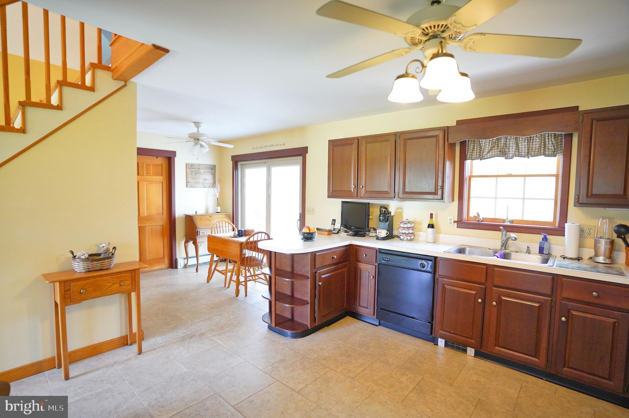 245 Montclair Road Gettysburg, PA 17325 - Photo 9 of 32 a kitchen with a sink a counter space dining table and stainless steel appliances