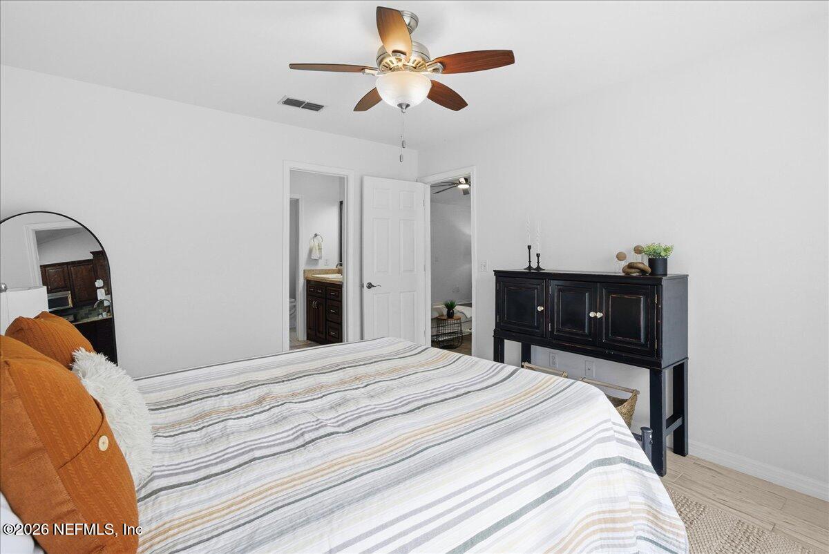 425 3rd Street West Baldwin, FL 32234 - Photo 16 of 47 a bedroom with a bed and a dresser