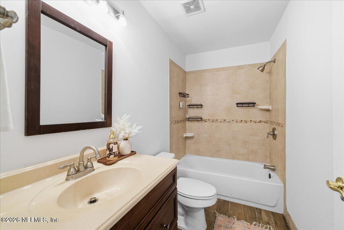 425 3rd Street West Baldwin, FL 32234 - Photo 17 of 47 a bathroom with a sink mirror toilet and bathtub