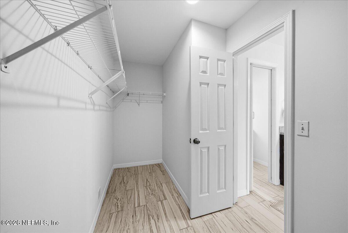 425 3rd Street West Baldwin, FL 32234 - Photo 20 of 47 a view of a hallway with wooden floor and staircase
