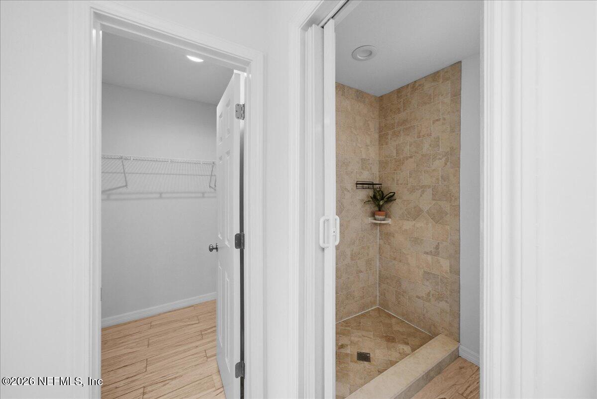 425 3rd Street West Baldwin, FL 32234 - Photo 21 of 47 a bathroom with a glass shower door