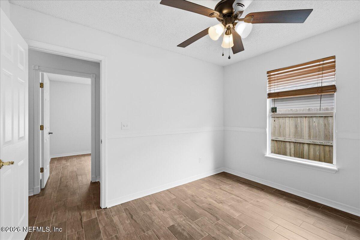 425 3rd Street West Baldwin, FL 32234 - Photo 26 of 47 a view of an empty room with a window and wooden floor