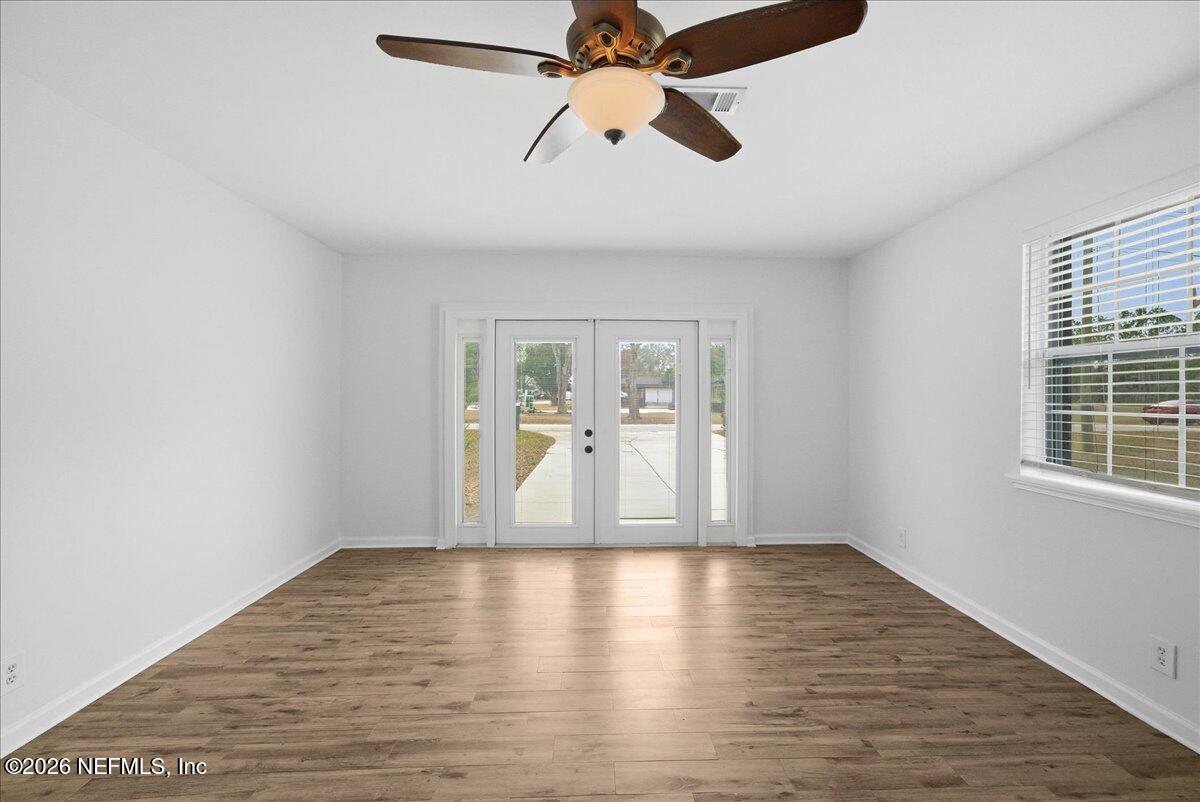 425 3rd Street West Baldwin, FL 32234 - Photo 29 of 47 a view of empty room with wooden floor and fan